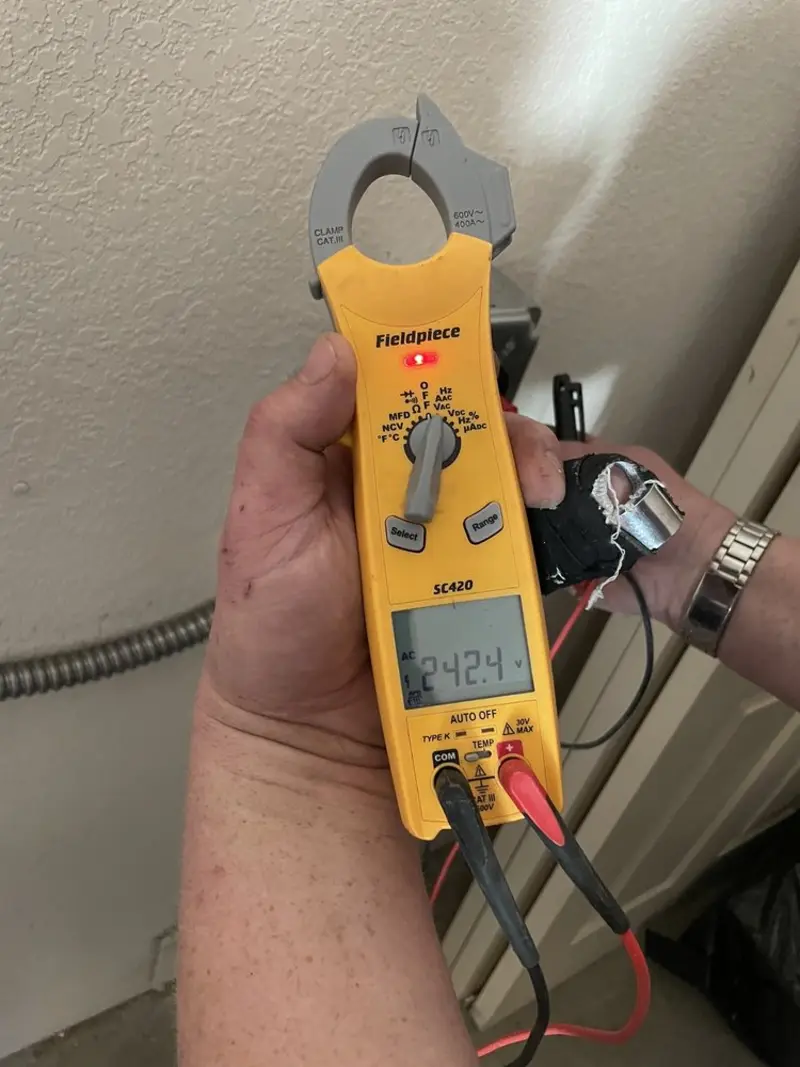 Voltage testing with clamp meter during Outlet Installation in Stuart